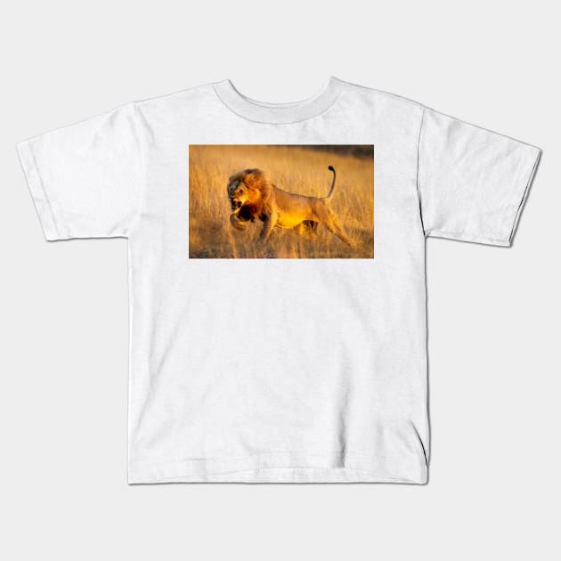 Aggressive young lion charging Kids T-Shirt by GrahamPrentice